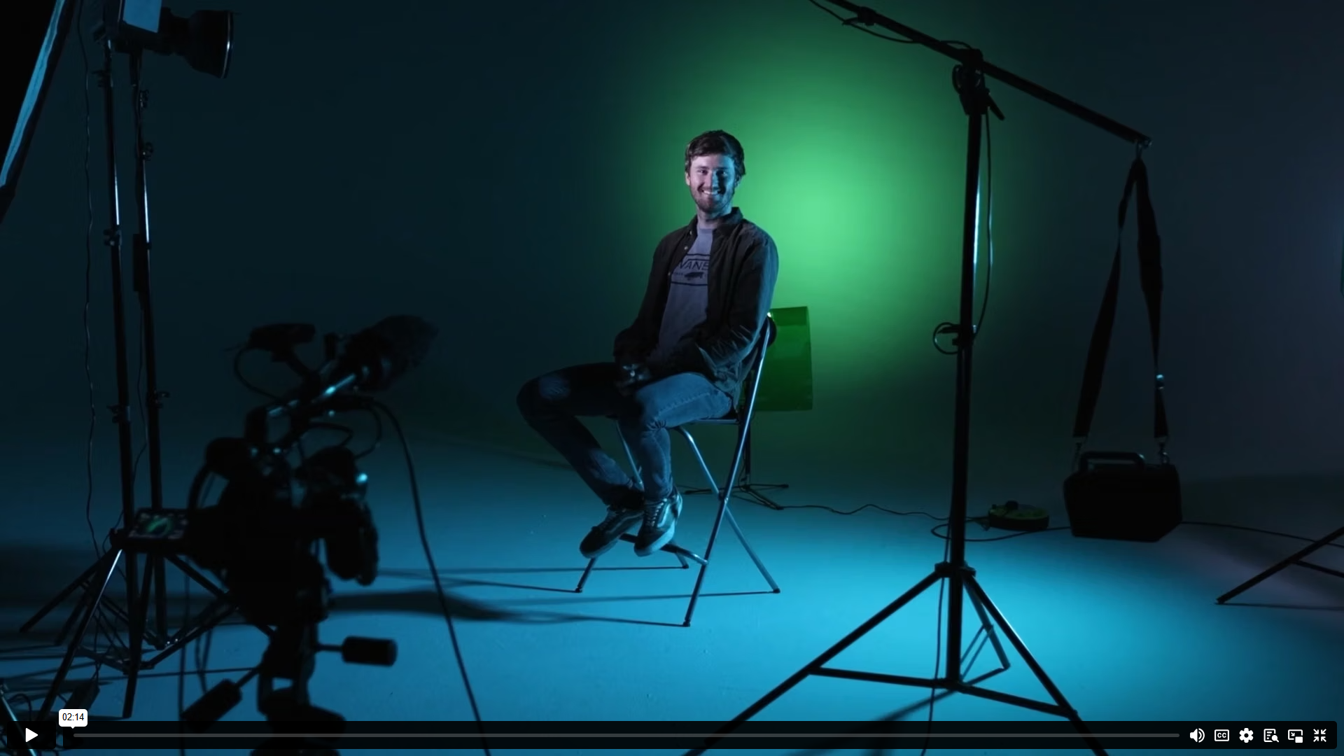 Athlete seated on set under green studio lighting