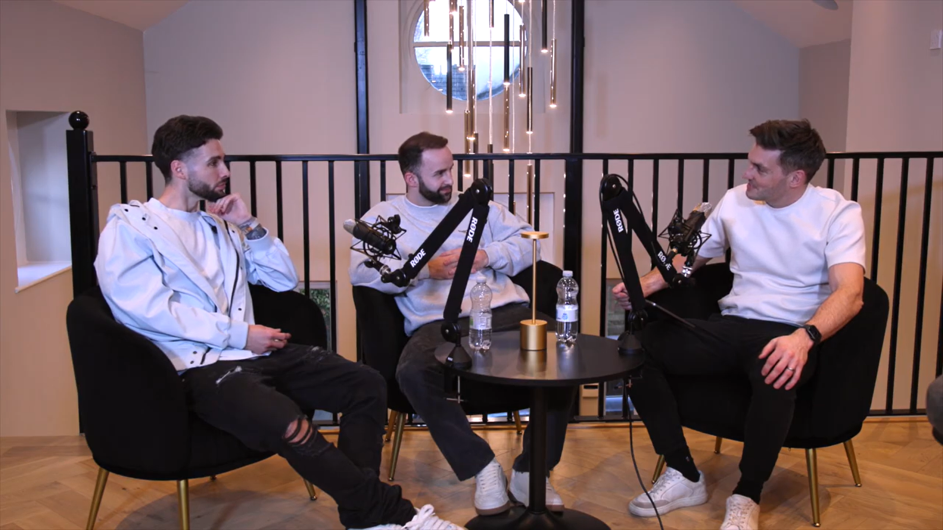 Hero — three people recording around a podcast table