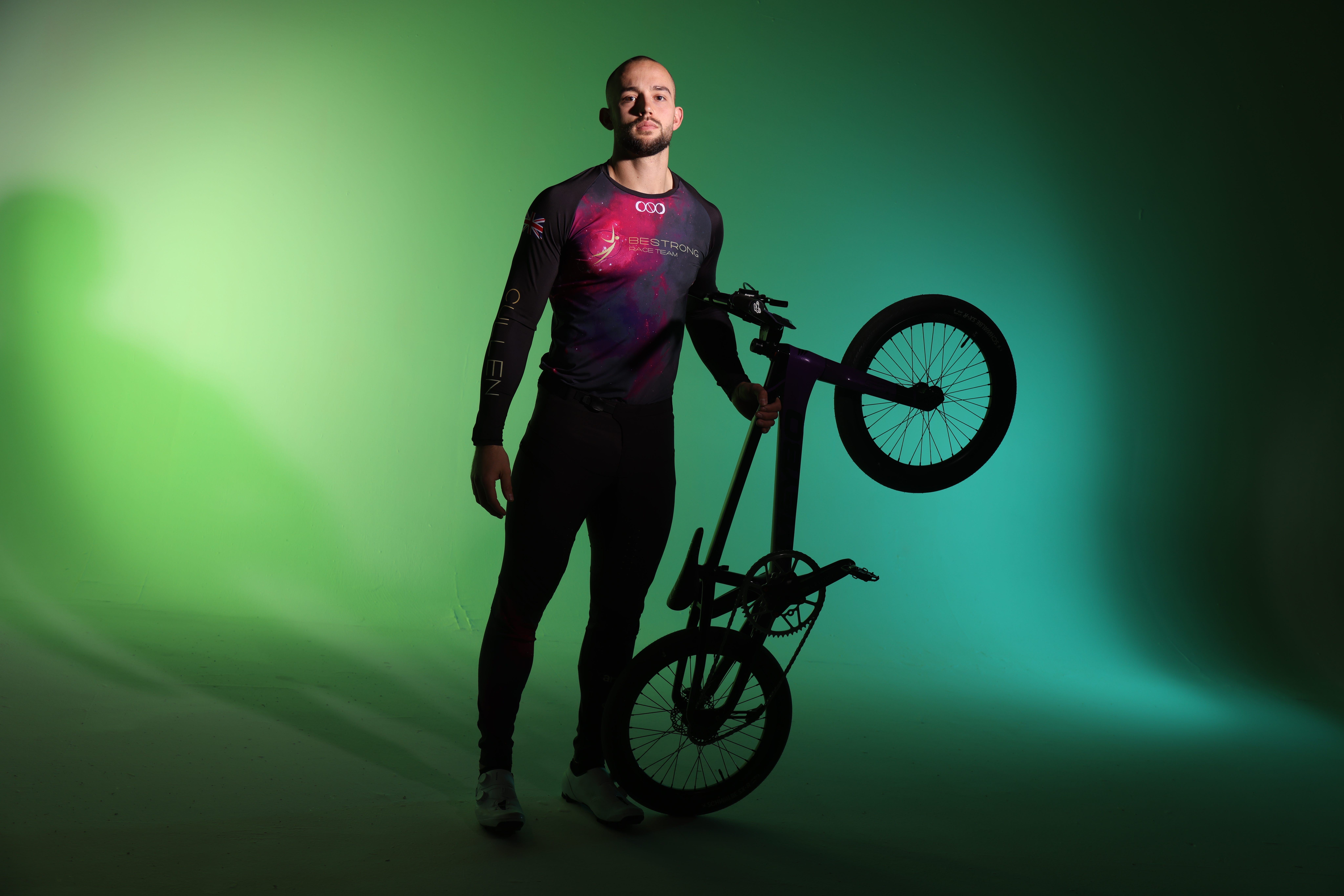 Hero — BMX racer in race jersey holding a bike