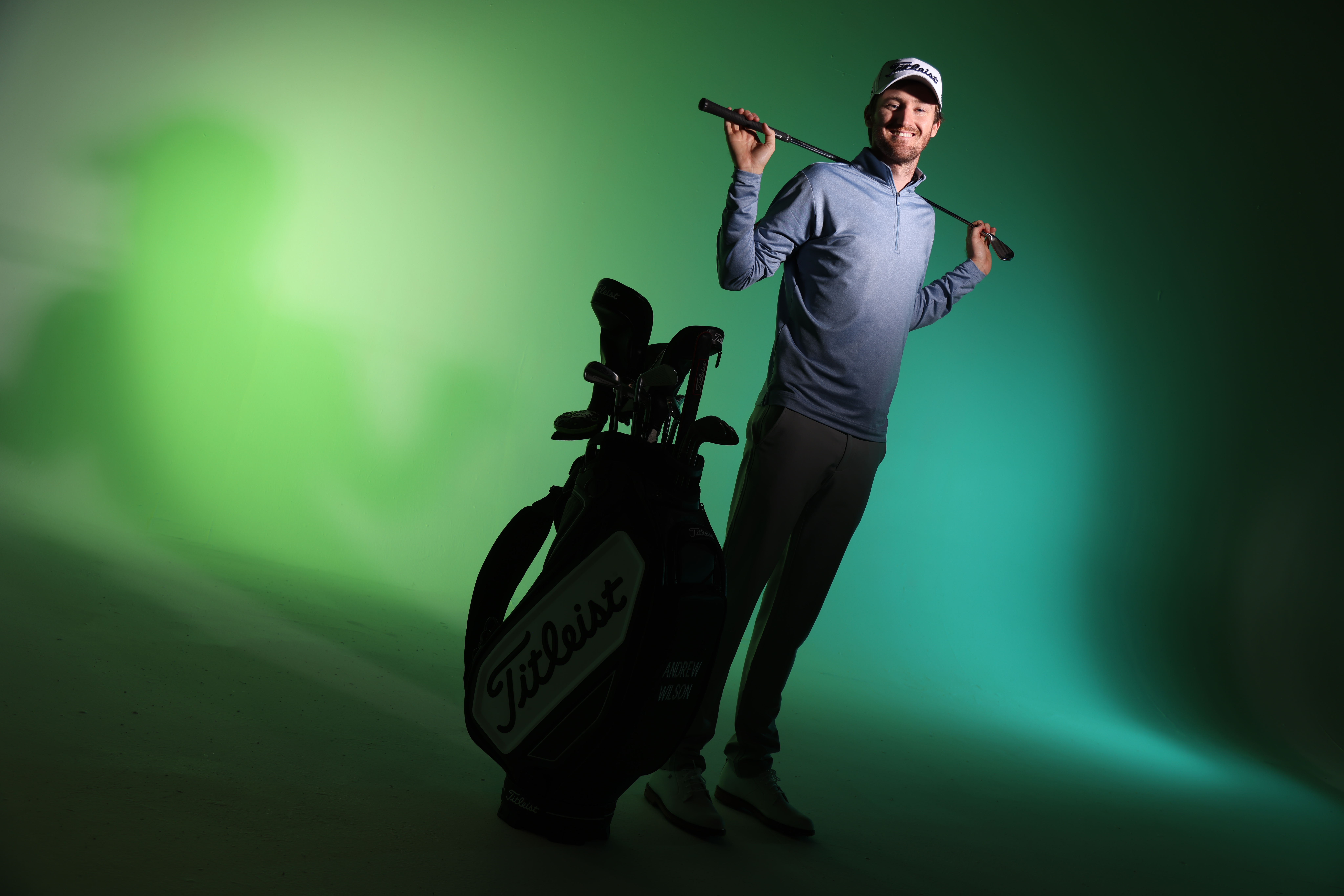 Hero — golfer walking with clubs over the shoulder