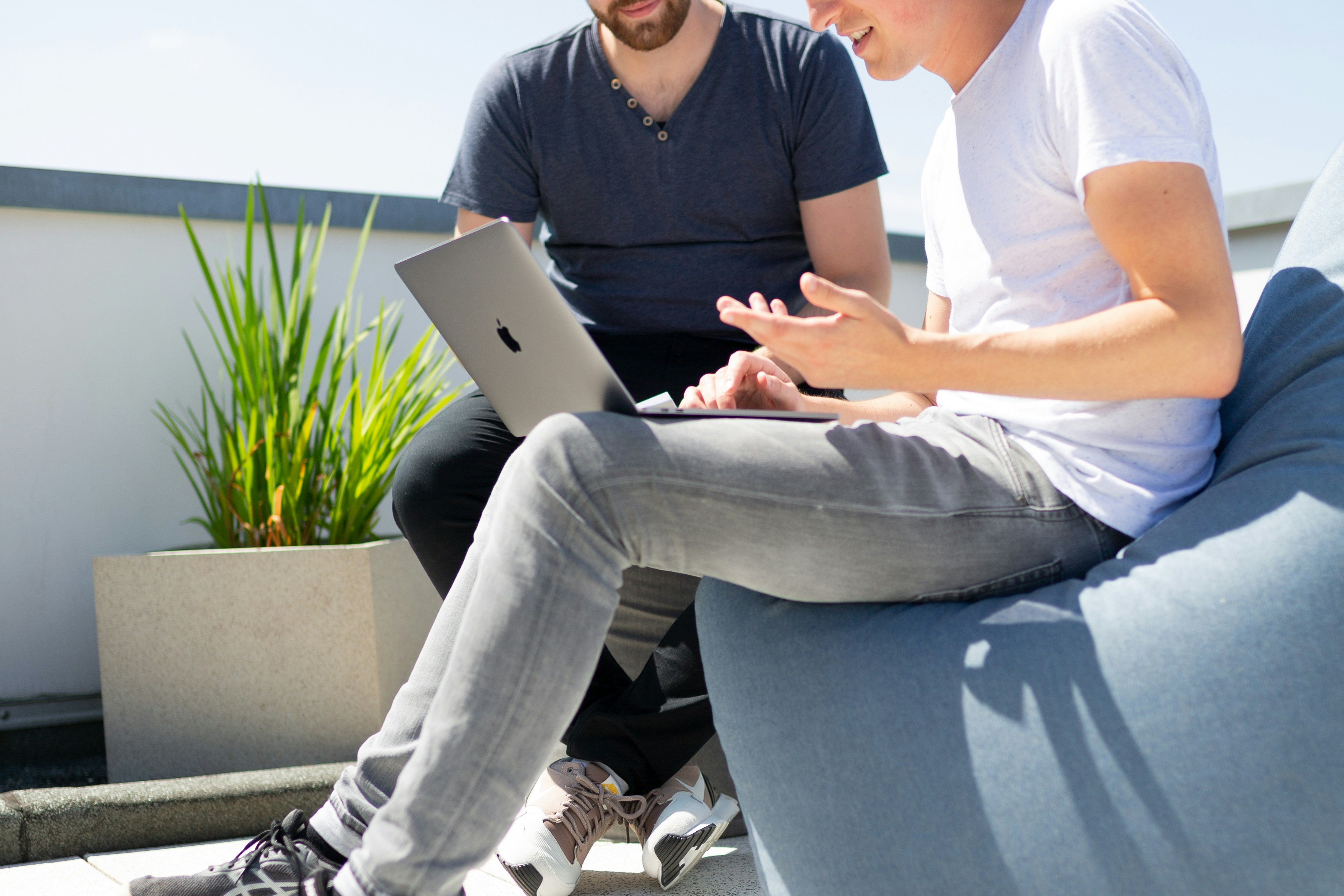 Hero — adviser and client in conversation, hands gesturing