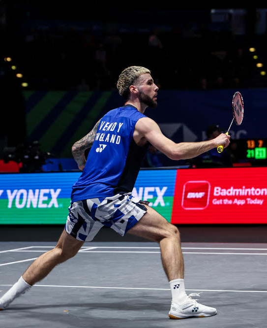Sean Vendy mid-rally in England badminton kit