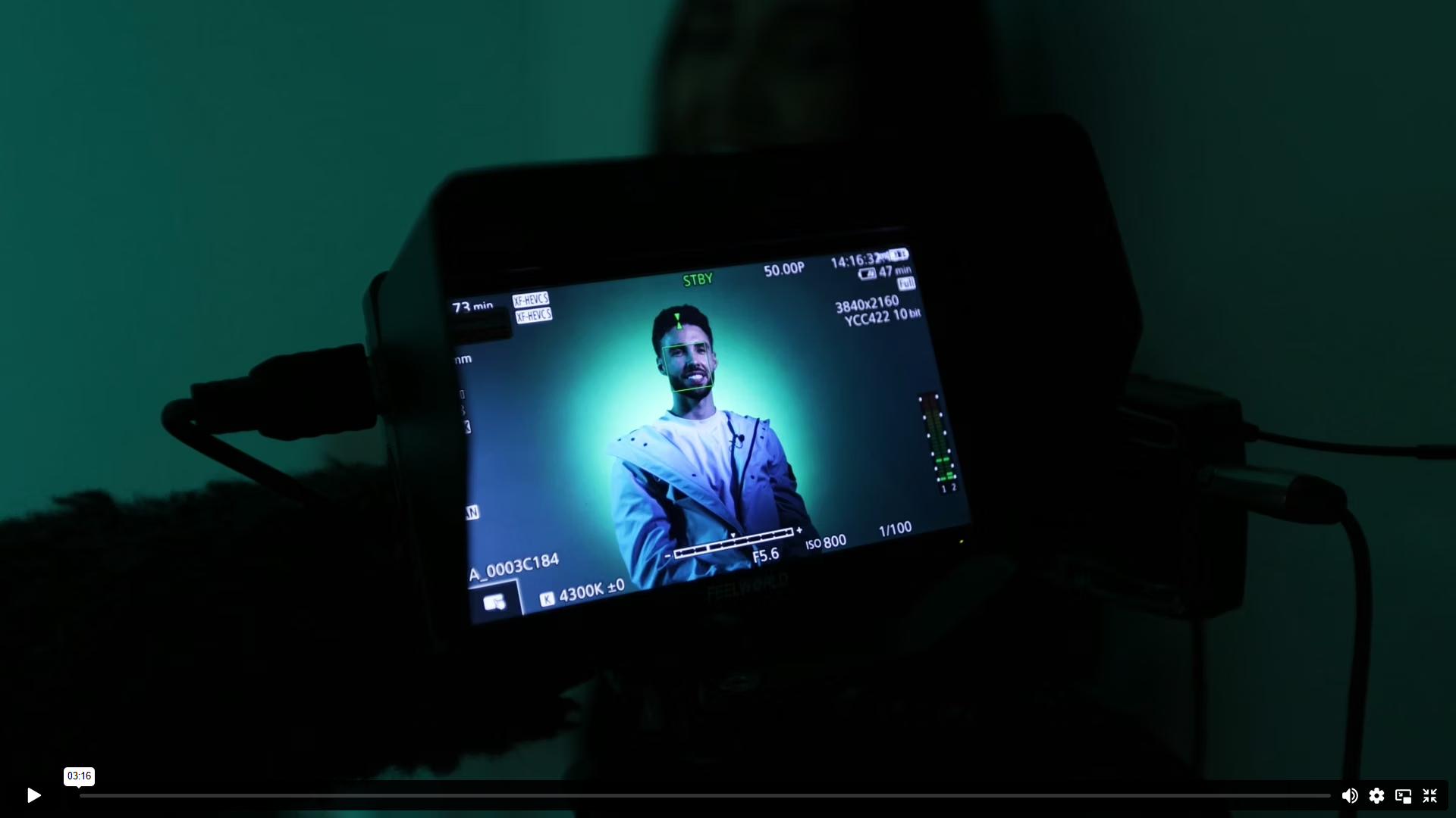 Video still — Sean Vendy seated on set, green studio lighting
