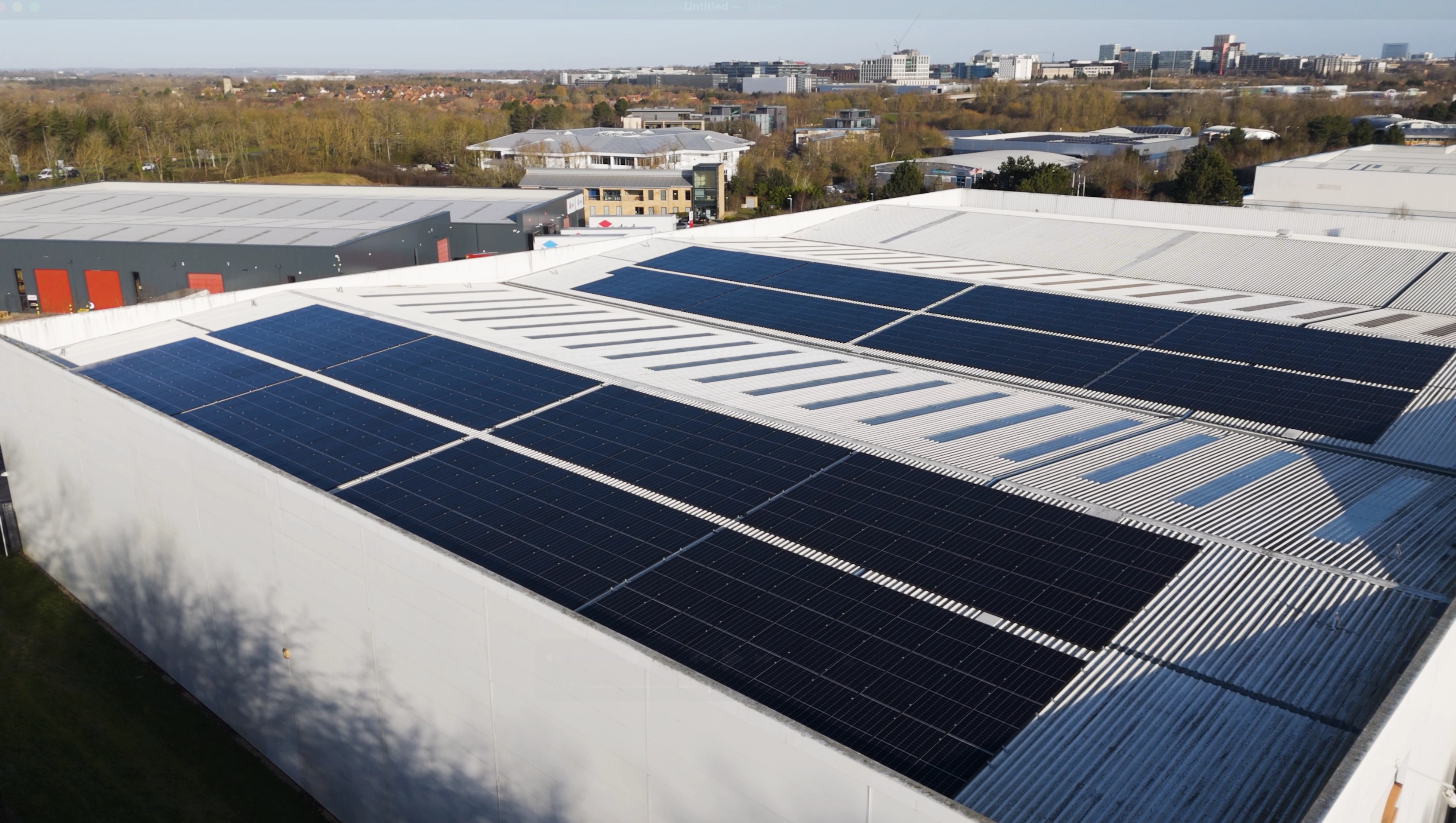 Solar panels installed on a large commercial warehouse roof generating renewable energy for business use