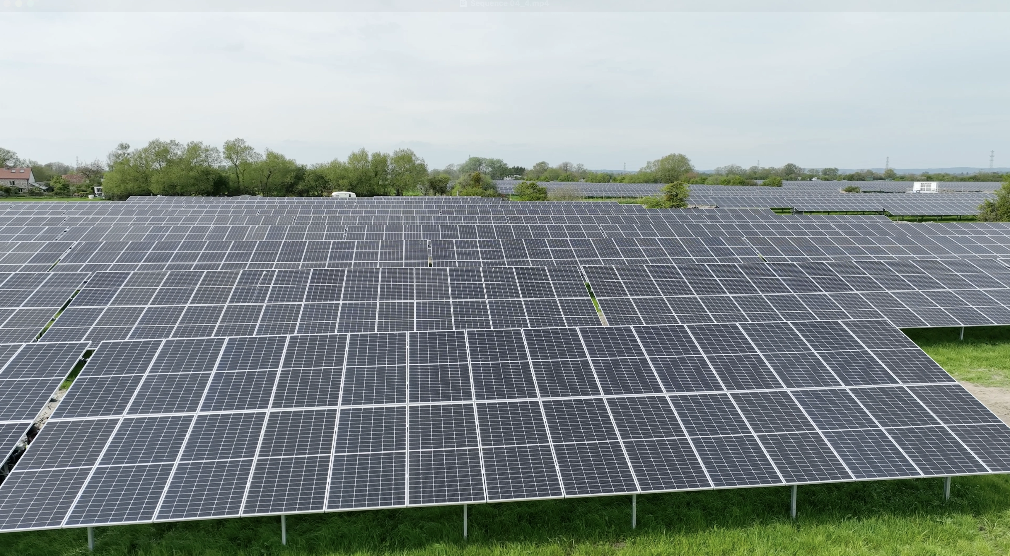 Extensive solar farm with rows of photovoltaic panels generating clean renewable energy in open countryside