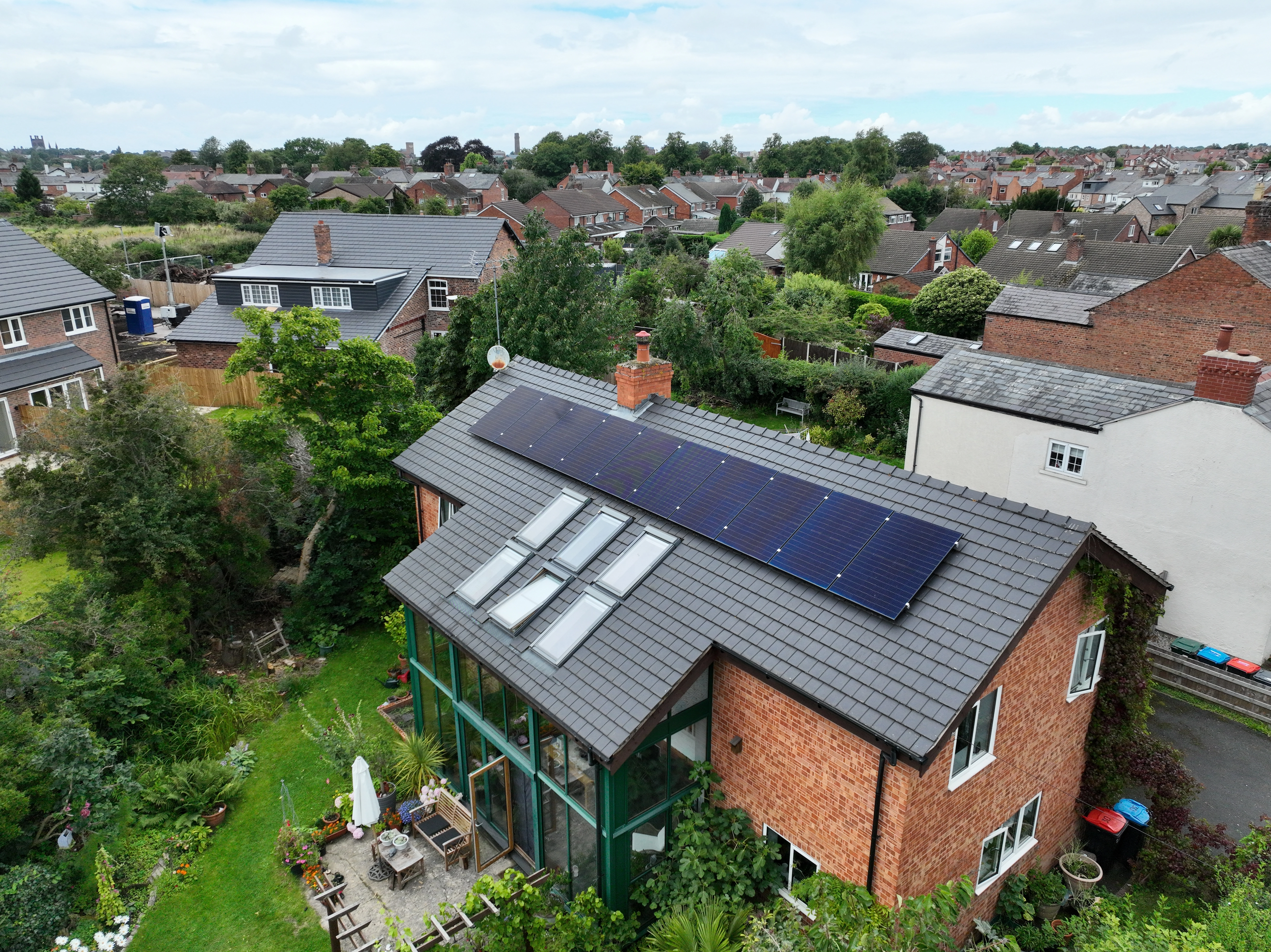 Residential solar panel installation on rooftop with multiple panels generating renewable energy