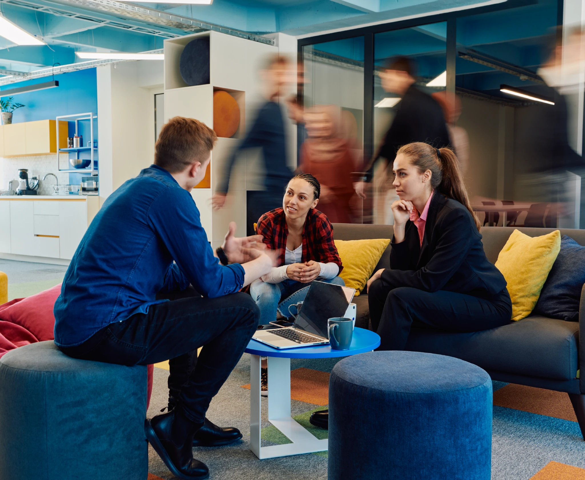 Tenos colleagues talking in a breakout area