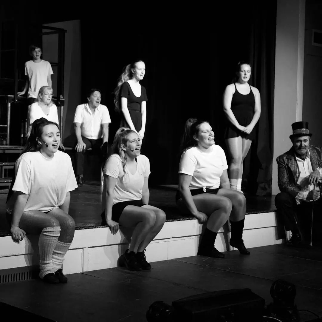 black and white image of the cast performing we'll meet again at St James's CofE Secondary School